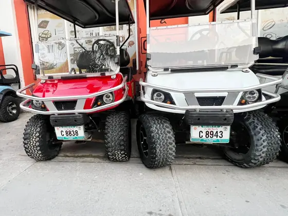 Gas powered golf cart rental parked by the beach in Belize
