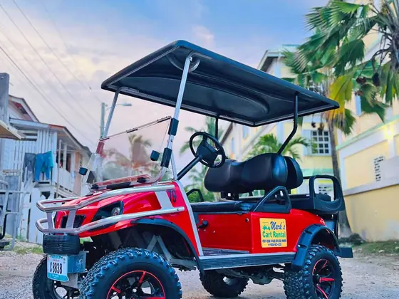 Gas golf cart rental on a sand street in San Pedro Town